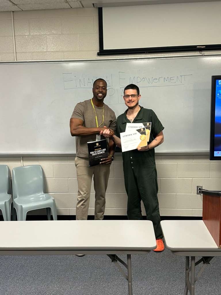 Aaron presenting certificate to program graduate