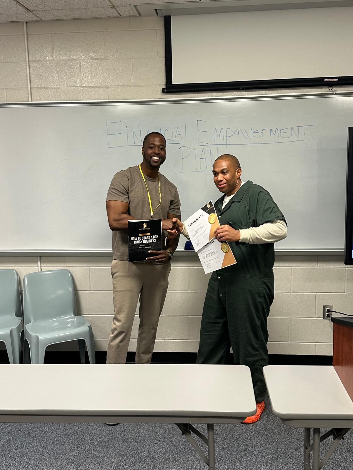 Aaron congratulating program graduate with certificate